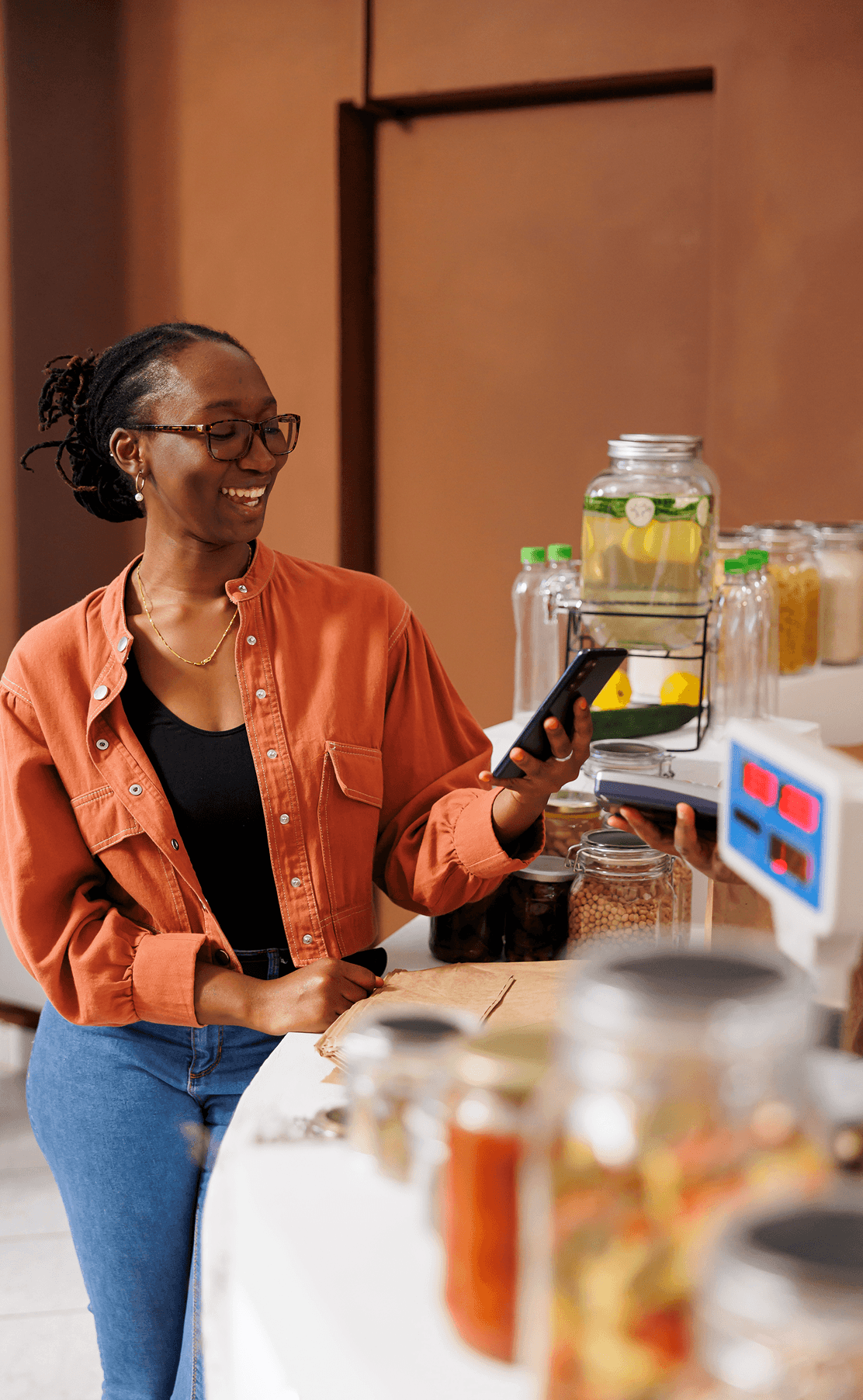Woman using a phone at a shop counter